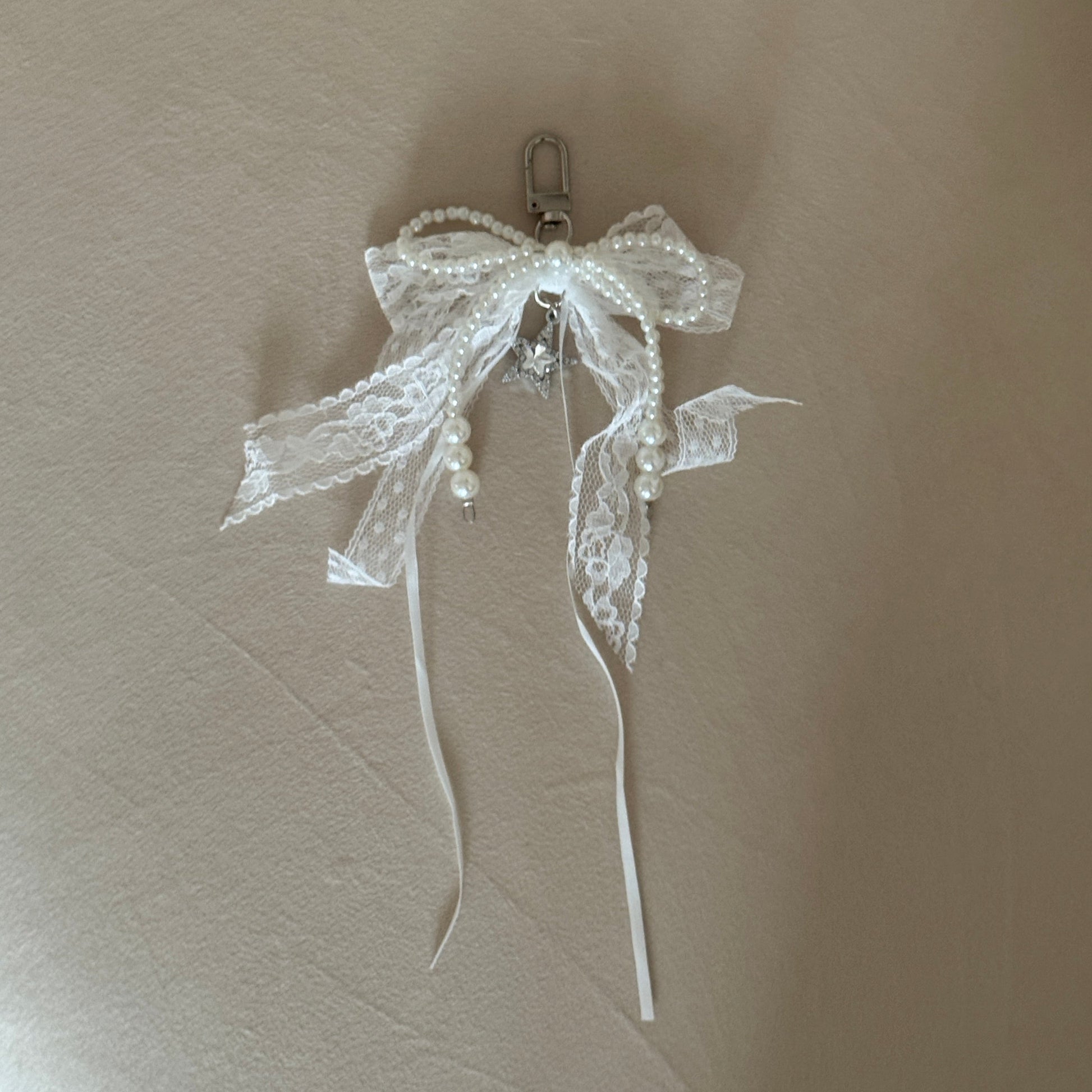 Decorative hair clip with a bow on a beige surface